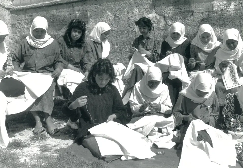 Women of the Cooperative embroidering together, archive photo