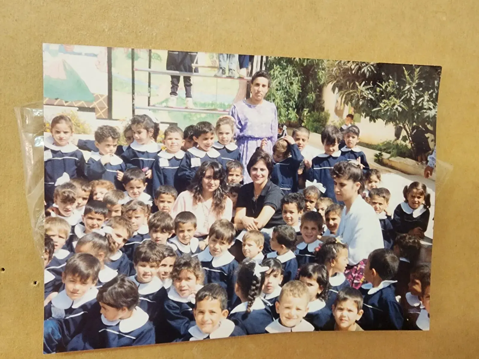A Takreem Kindergarten class photo with their teacher